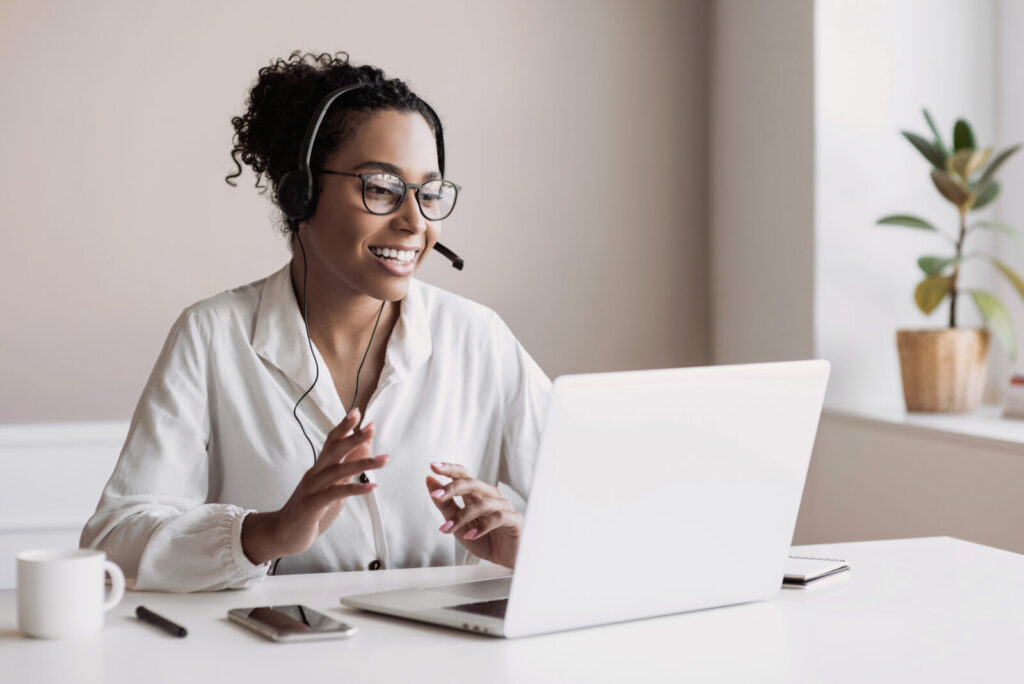 Smiling medical professional using laptop to communicate